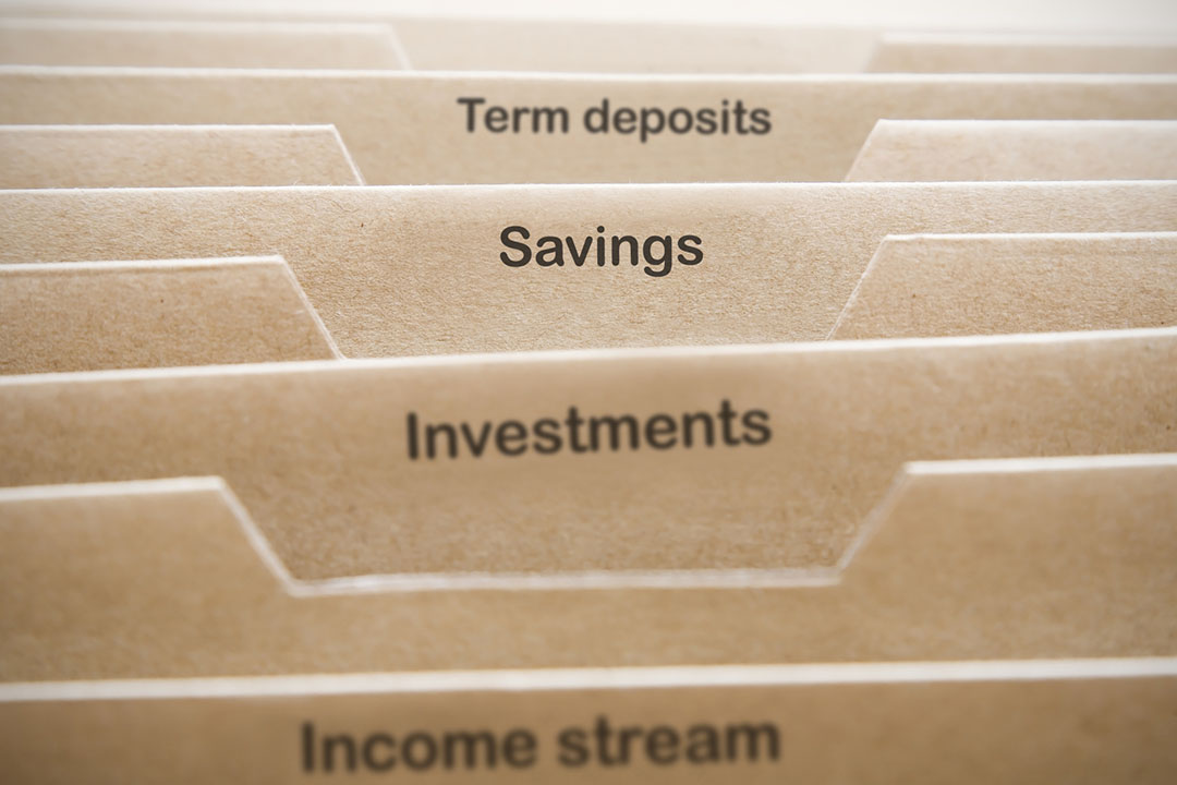 Image showing an administration folder with named tabs for topics such as income stream, investments, savings and term deposits.