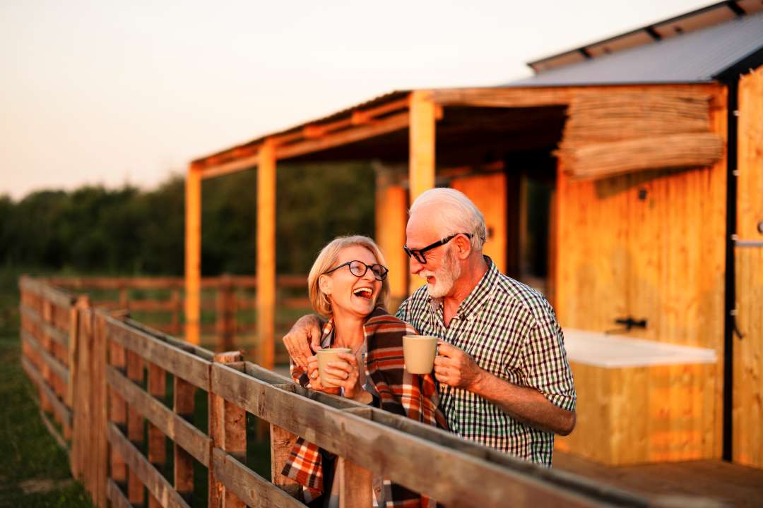 Retired couple drinking coffee outdoors