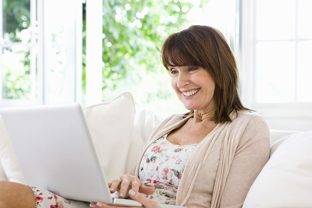 Woman on laptop on couch
