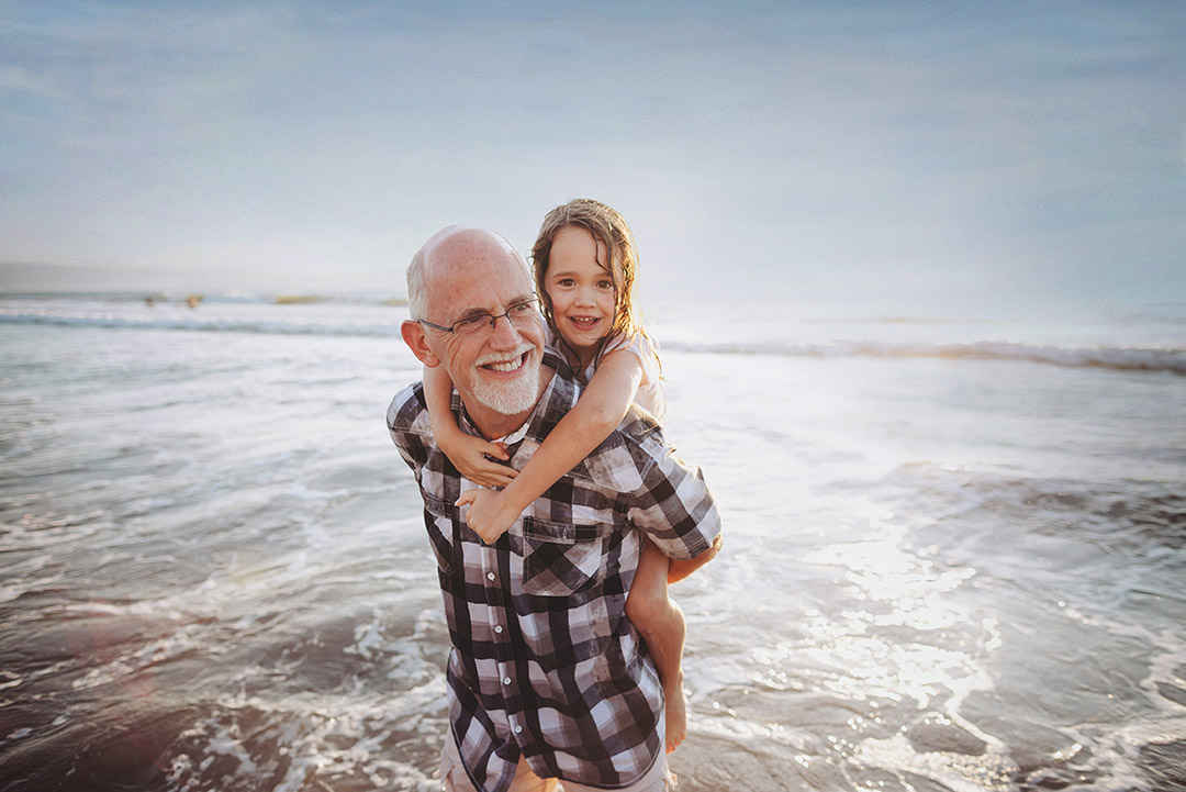 Older man with young girl on the beach